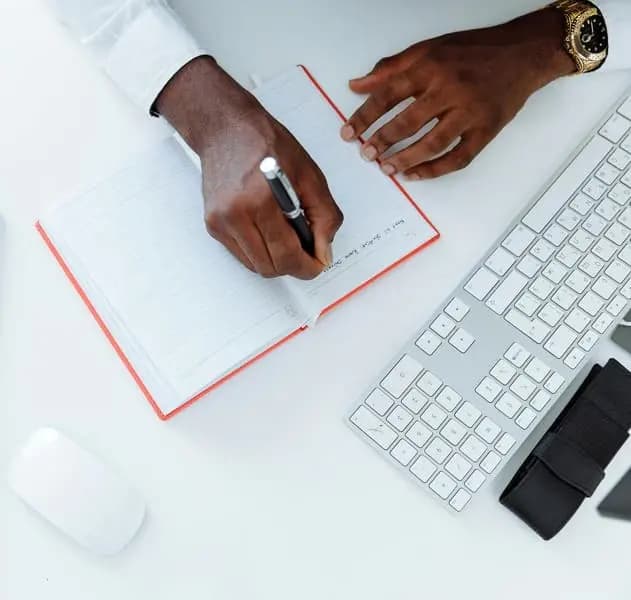 A businessman writes on a notebook